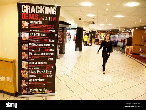 A Woman Walking Past The Welcome Break Cafe Sign In The Membury