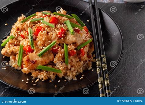 Tori Chahan Fried Japanese Rice with Vegetables and Chicken in Soy Sauce in a Black Plate on a ...