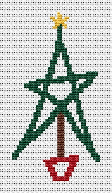 A Cross Stitch Christmas Ornament With A Star In The Center And A Tree