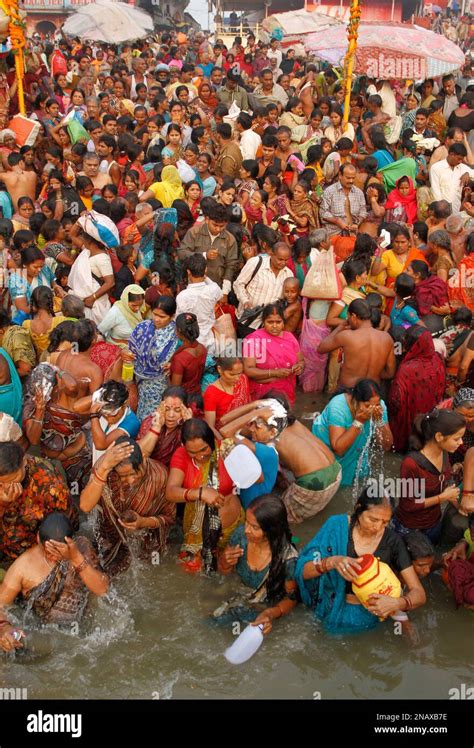 Devotees Take A Holy Dip During Dev Deepawali Festival On The Banks Of