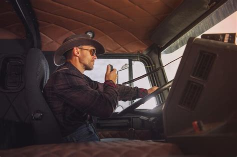 Premium Photo | Caucasian trucker wearing western style outfit driving ...