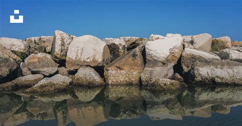 White rock formation on water photo – Free Riflessioni Image on Unsplash