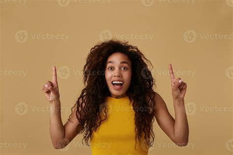 Amazed Young Attractive Long Haired Curly Brunette Woman With Dark Skin