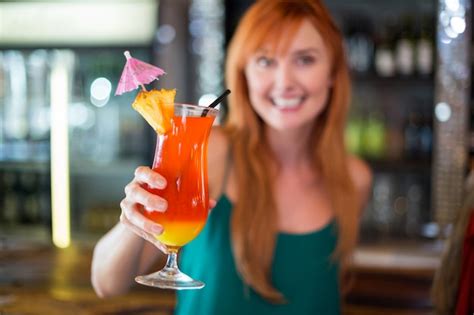 Premium Photo Portrait Of Happy Woman Holding A Cocktail Glass At Bar