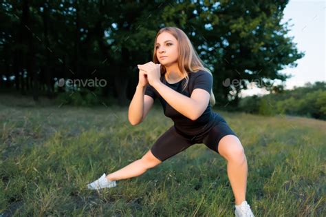 Athletic Blonde With A Slim Figure Performs Strength Exercises For Squats Stock Photo By