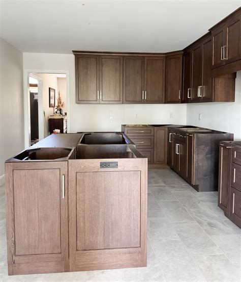 The kitchen shows a view of newly installed custom wood cabinets with