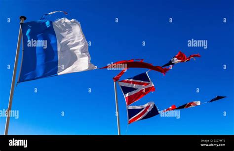 Torn French And British Flags In The Wind Stock Photo Alamy