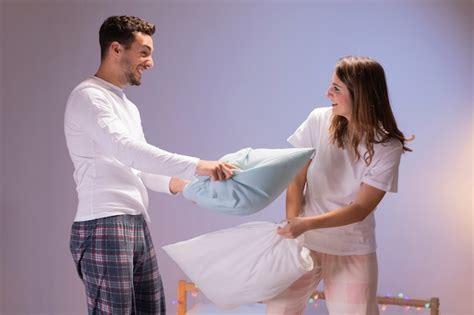 Couple Having A Pillow Fight Free Photo