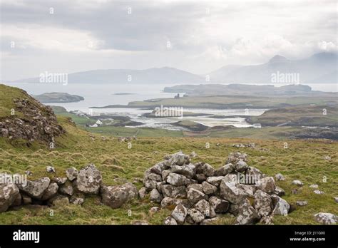 View From Canna Island Of Isolated Houses And The Island Of Sanday