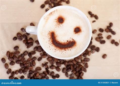 Smiley Face In Cappuccino With Coffee Beans On Table Stock Image