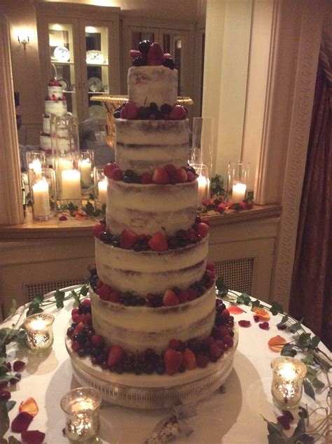 Tier Semi Naked Cake Decorated With Fresh Berries And Displayed Surrounded By Sumptuous Candle
