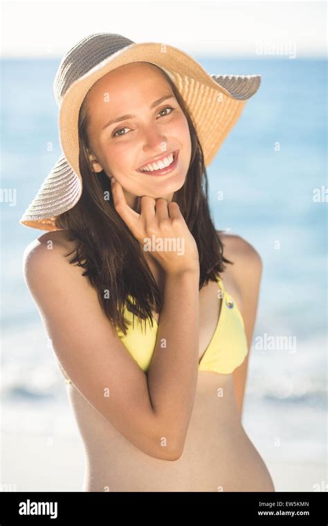 Brunette Relaxing With A Straw Hat Smiling At Camera Stock Photo Alamy