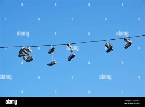 Sports Shoes Are Hanging On Wiressneakers Suspended By Laces On