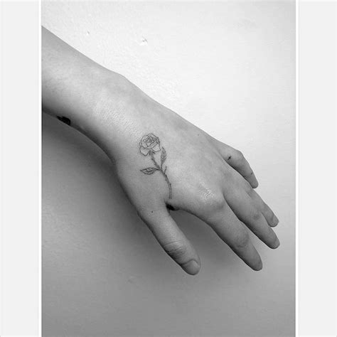 Fine Line Rose Tattoo Located On The Hand