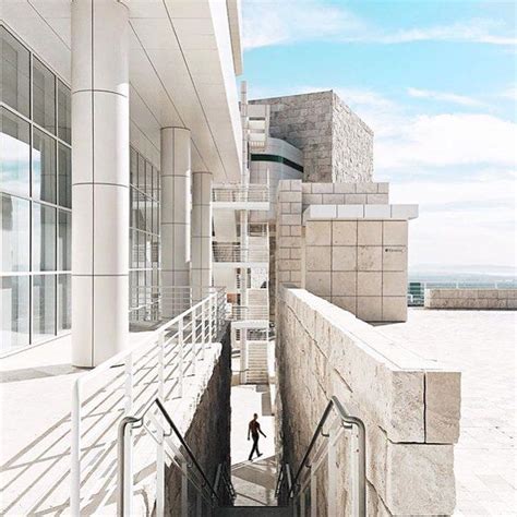 A Person Walking Up Some Stairs In Front Of A Building