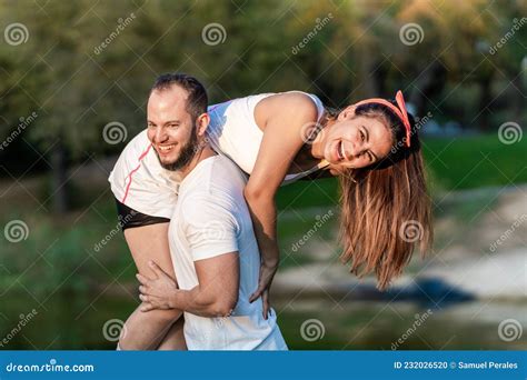 Man Carrying and Joking with a Woman on Inline Skates in a Park. Stock ...