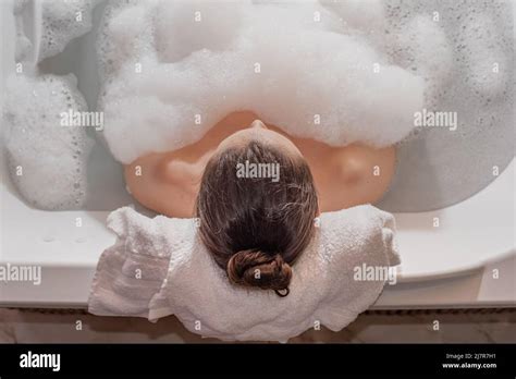 Woman Relaxing In Hot Bath Tub With Soap Foam Stock Photo Alamy