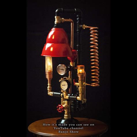 A Red Lamp Sitting On Top Of A Wooden Table Next To A Black Background