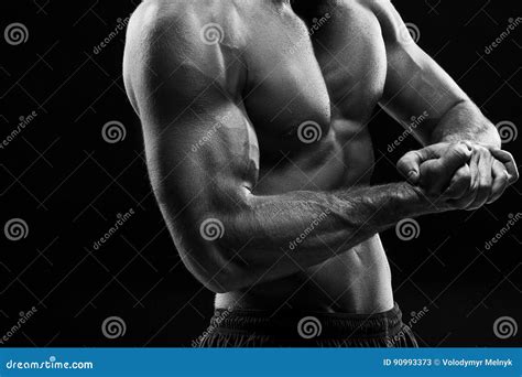 The Torso Of Attractive Male Body Builder On Black Background Stock