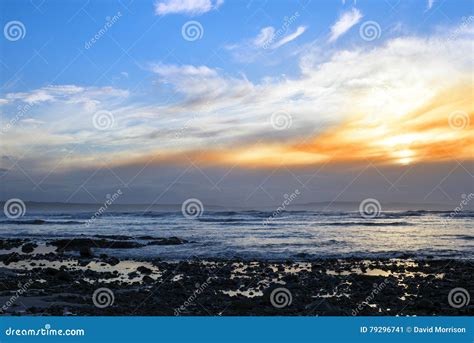 Beautiful Yellow Sunset Sky Over Rocky Beach Stock Image Image Of