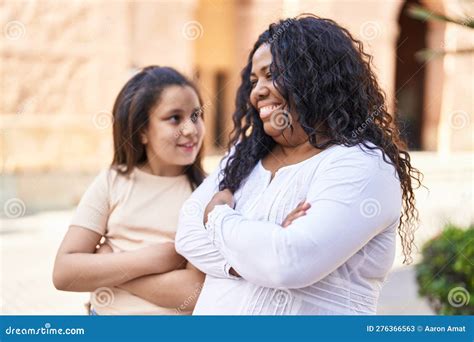 Mother And Daughter Smiling Confident Standing With Arms Crossed