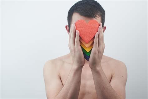 Premium Photo The Lgbt Community Concept Gay Guy Holds In His Hands The Hearts The Colors Of