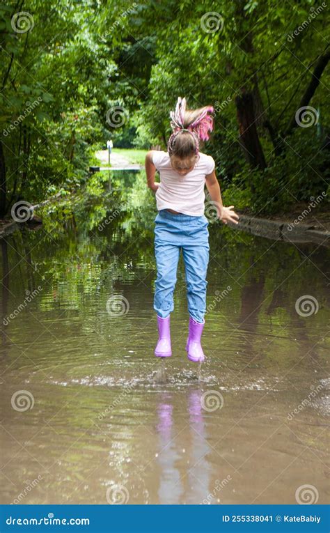 A Girl Is Playing In Muddy Puddles Stock Image Image Of Girl Forest