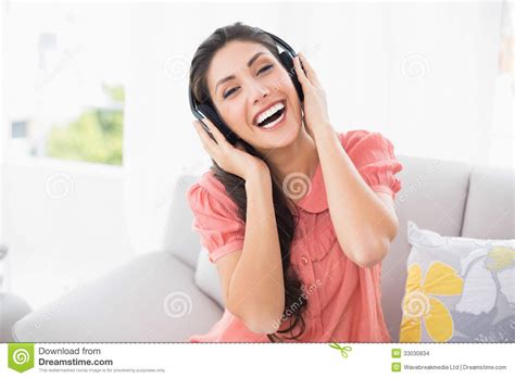 Pretty Brunette Sitting On Her Sofa Listening To Music Stock Photo Image Of Adult Apartment