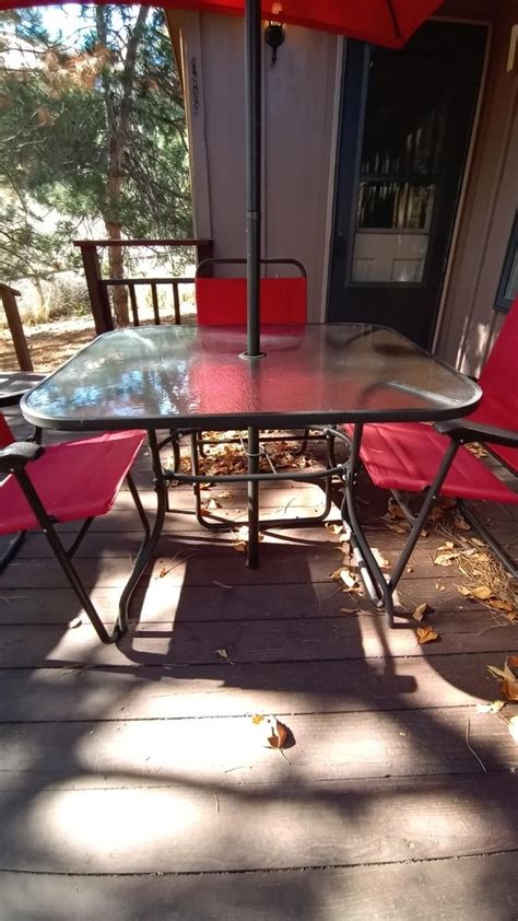 FROSTED GLASS PATIO TABLE-UMBRELLA-FOUR FOLDING CHAIRS | EstateSales.org