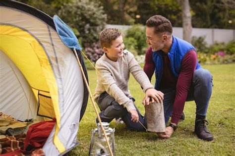 Premium Photo Caucasian Father And Son Smiling While Setting Up A