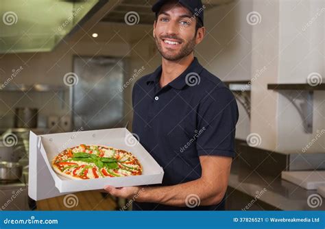 Happy Pizza Delivery Man Showing Fresh Pizza Stock Image - Image of ...