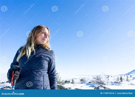 Brave Mountaineer Woman Walking Alone With Rucksack In The Snow