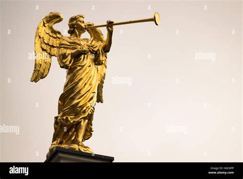 Golden statue of an angel with a trumpet and copy space Stock Photo - Alamy