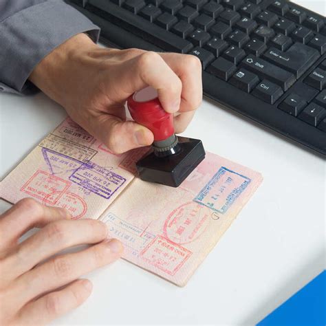 Immigration Officer Stamping A Passport At Border Control Travel Off Path