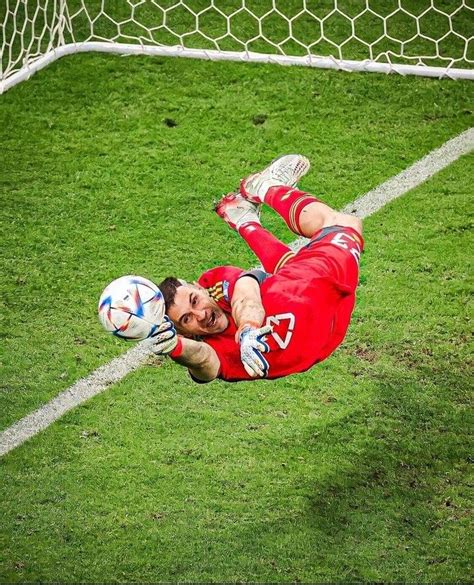 A Soccer Player Is Diving For The Ball