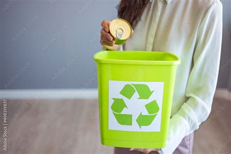 Recycling, waste sorting and sustainability concept - hand throwing tin ...