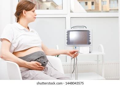 Pregnant Woman Sitting Clinic Performing Cardiotocography Stock Photo