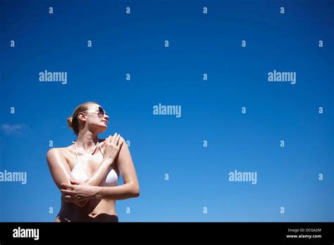 A Lady In Bikini And Sunglasses Posing Under Bright Sky Stock Photo Alamy