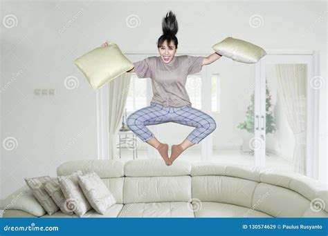 Excited Asian Woman Jumps With Pillows Stock Image Image Of Holding