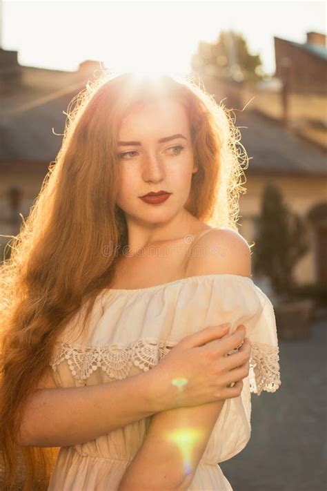 Street Portrait Of Sensual Redhaired Model With Long Waving Hair Stock