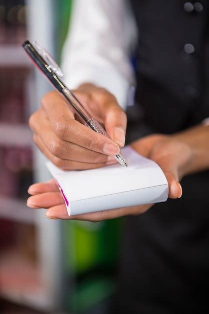 Premium Photo Waiter Writing Down An Order In A Bar