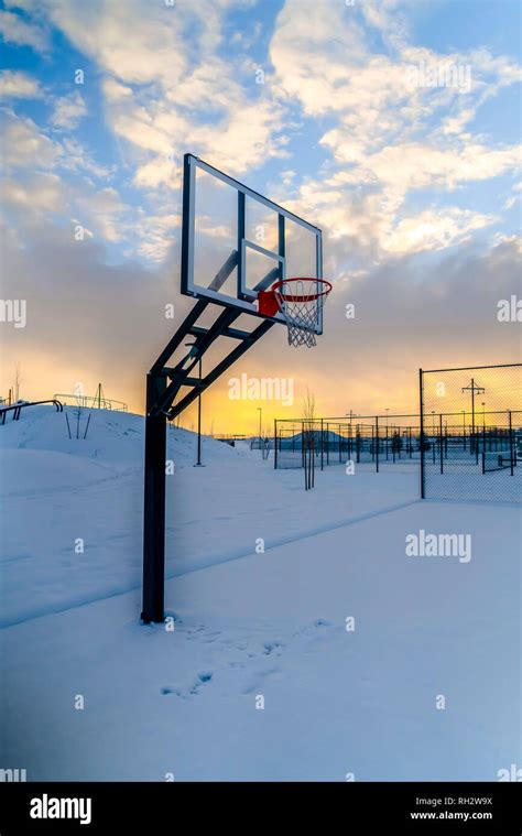 Snow Covered Outdoor Basketball Court At Sunset Stock Photo Alamy