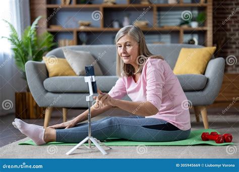 Senior Mature Gray Haired Woman Doing Fitness Sitting On Exercise Mat