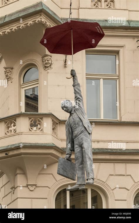 The Umbrella Man Of Praguea Modern Art Statue Of A Man Hanging From An