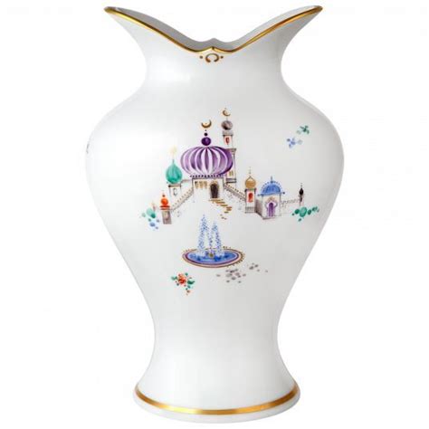 An Ornate White Vase With Gold Trimming