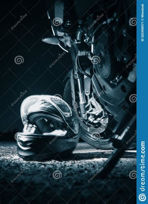Motorcycle And A Helmet On The Ground At Night Stock Image Image Of