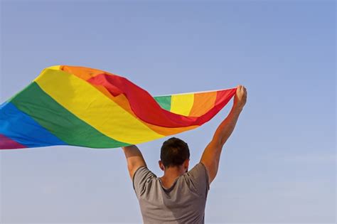 Premium Photo Man Holding Raised Hands Waving Lgbt Rainbow Flag