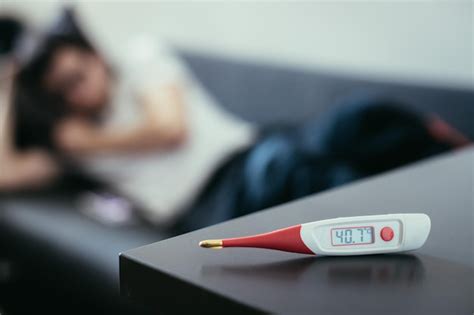 Premium Photo Illness And Fever Thermometer And Ill Man Lying On The