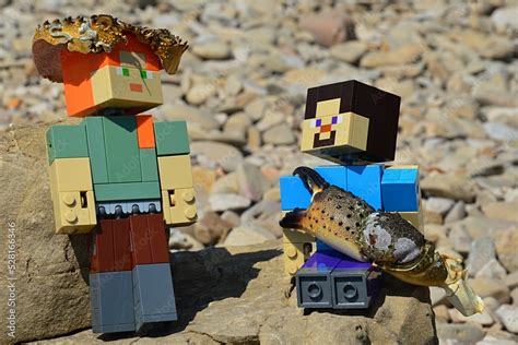 LEGO Minecraft figures of Steve and Alex on shoreline rock, Alex standing with crab ...