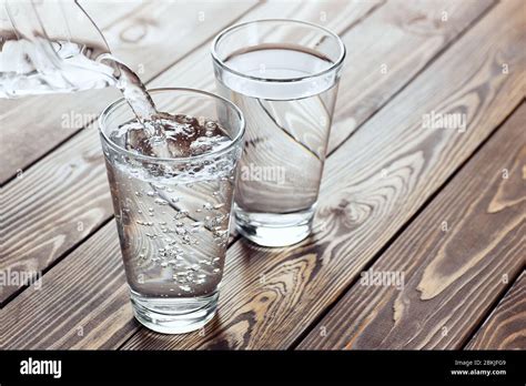 Water Pouring From Jug Into Glass Stock Photo Alamy